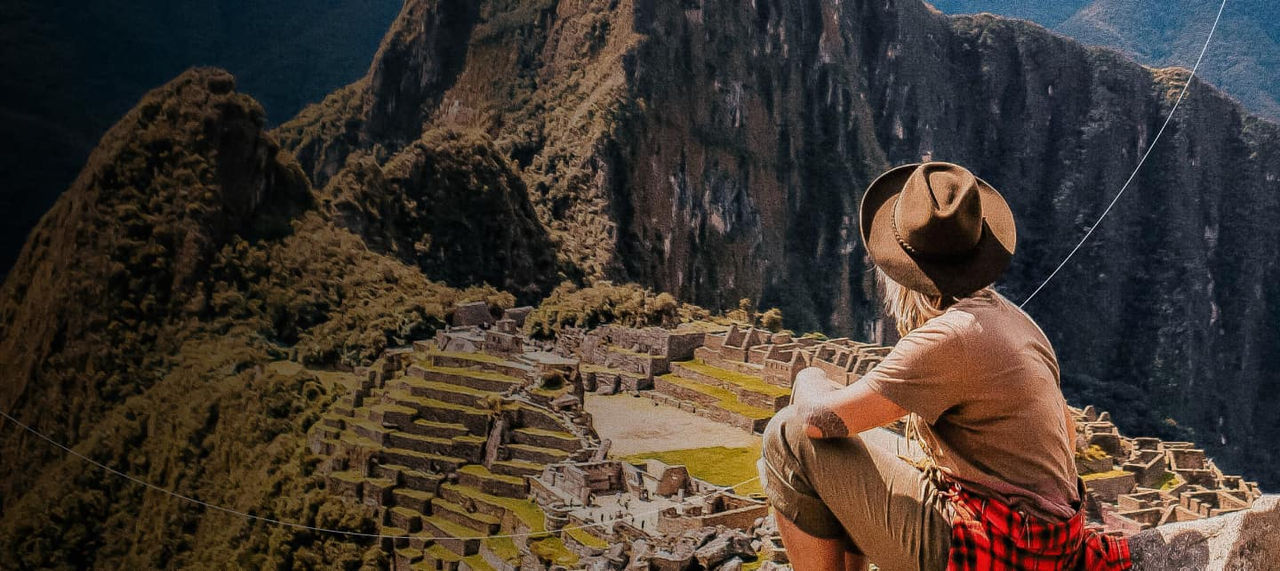 woman sitting overlooking machu picchu