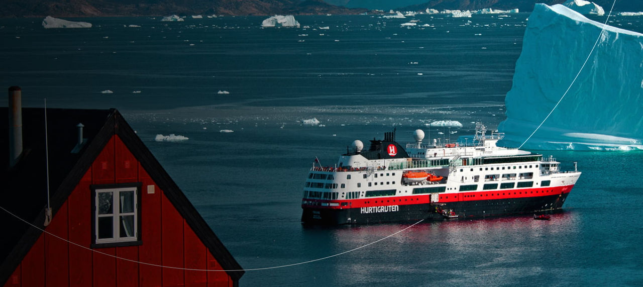 red house among arctic icebergs