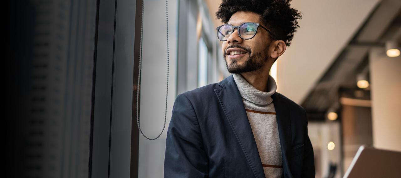 Man in office looking outside