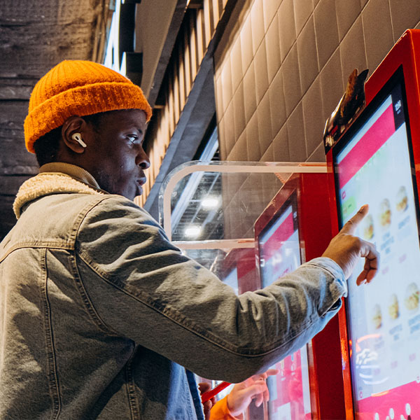Man operating a digital food kiosk
