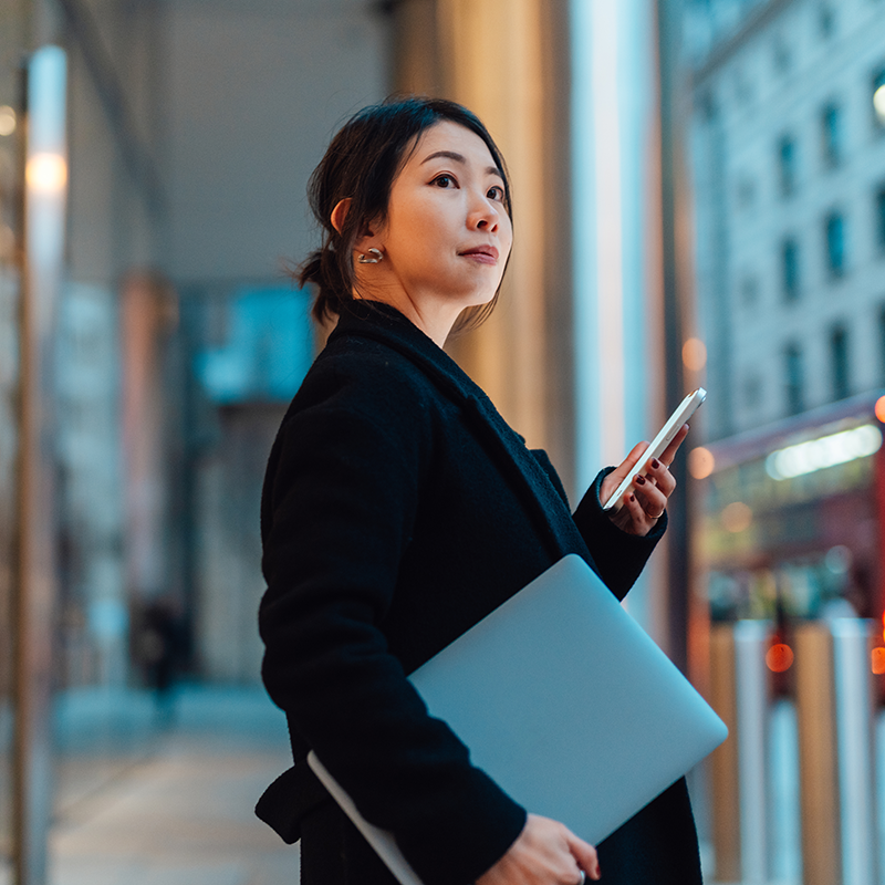 Woman on her phone outside a financial institution