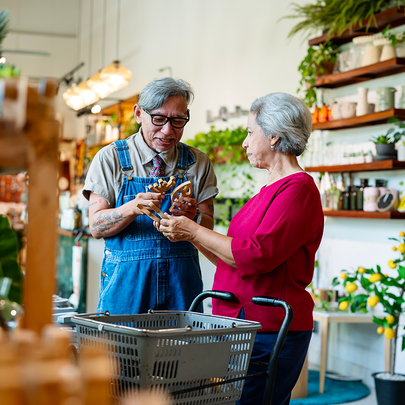 Older woman working with an older store clerk to make a selection