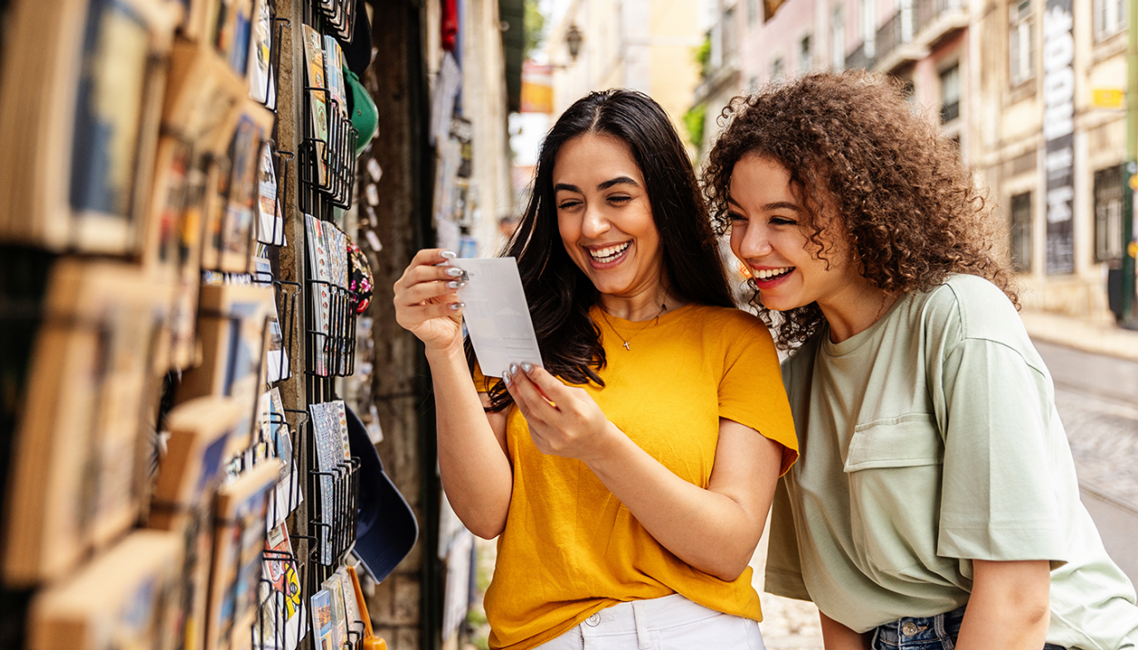 Women looking at postcards during their trip