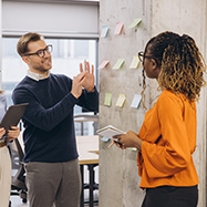 Office workers brainstoring with postit notes.
