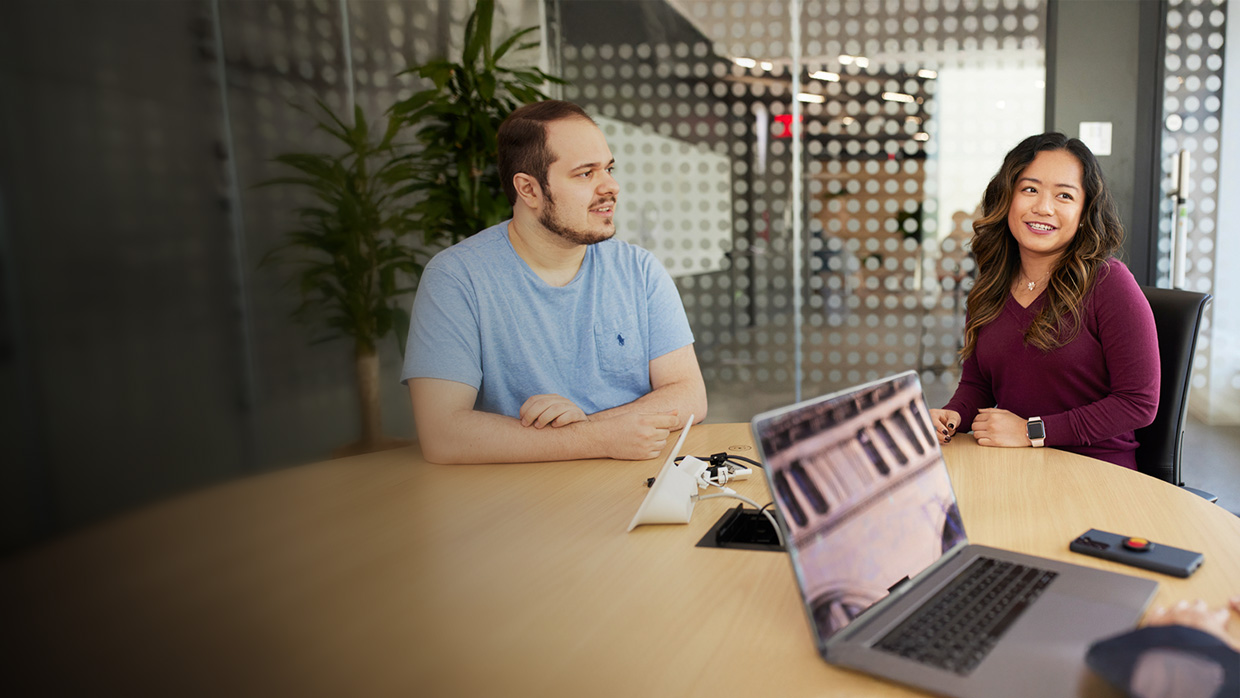 Colleagues working together in a meeting room.