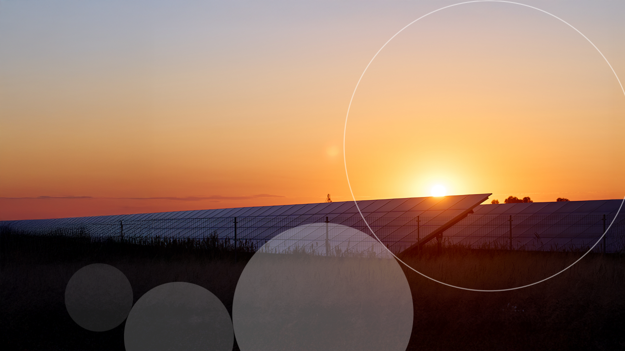 Woman standing inside glass office building.