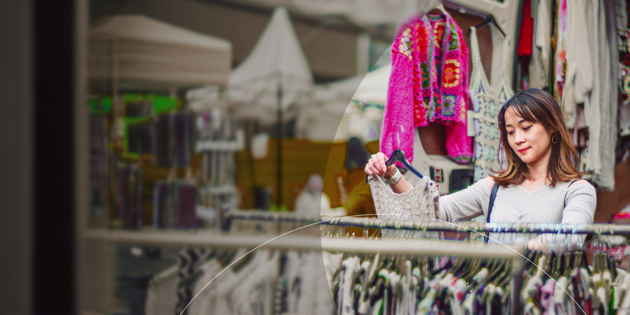 Woman standing inside glass office building.