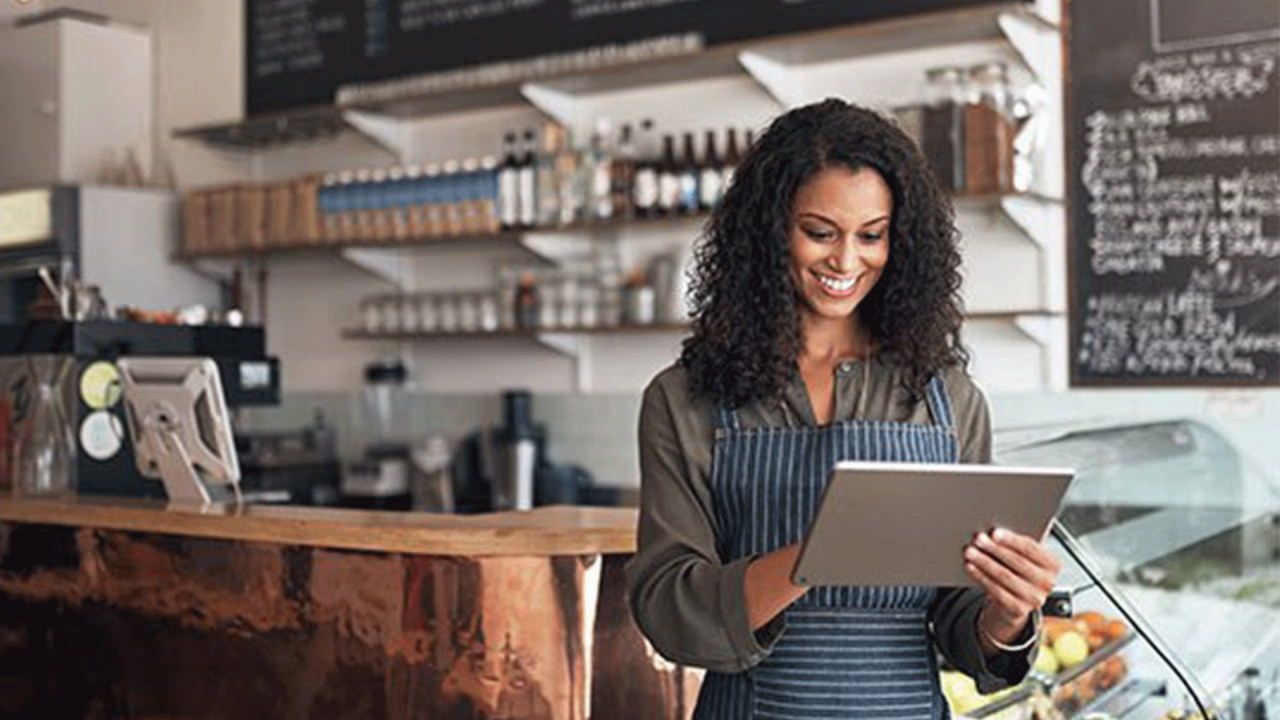 woman checking transaction on tablet