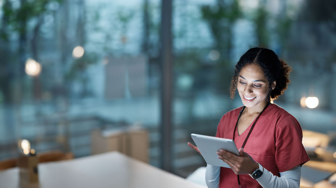 Nurse, medical tablet and black woman in hospital working late on telehealth, research or online consultation. Tech, healthcare or female physician with technology for wellness app in clinic at night.