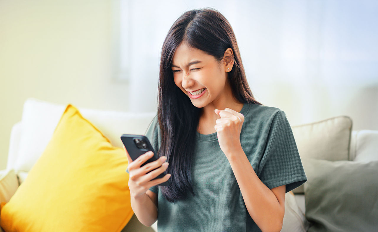 Excited young asian woman.