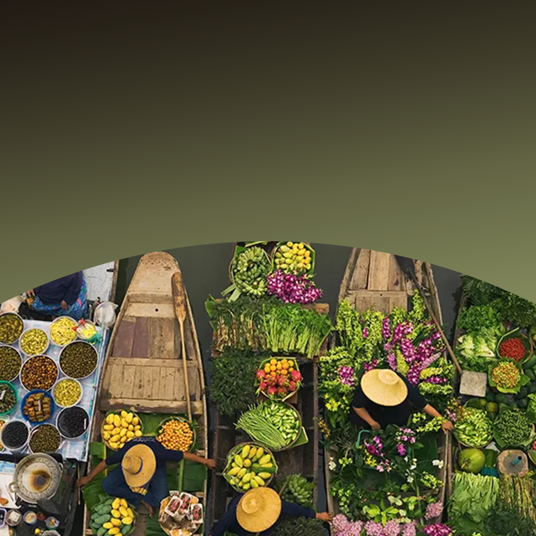 Aerial view of boats filled with colourful fruits and vegetables.