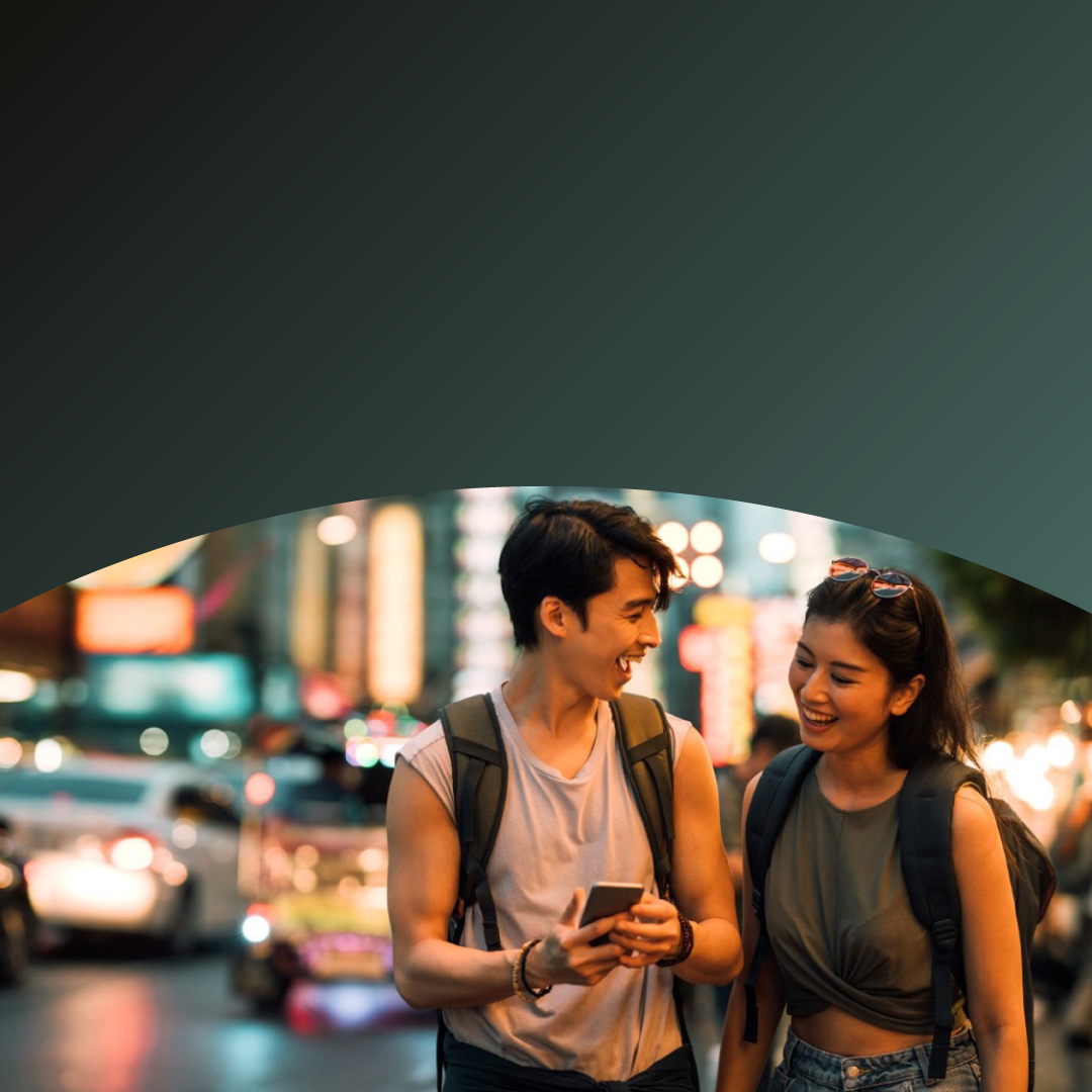 Tourist man and woman laughing looking at the smartphone.