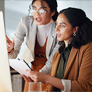 woman employee looking at computer in office.