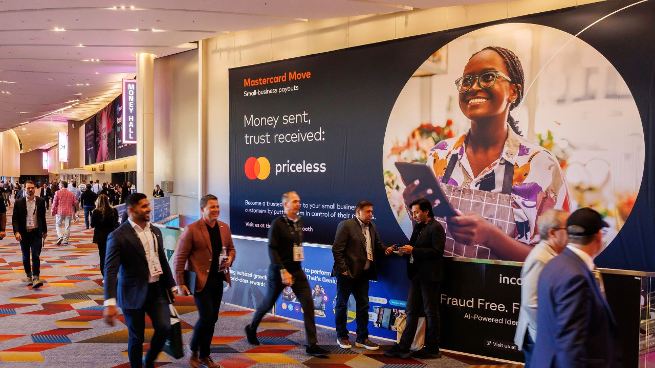 Money 2020 attendees walk down the hall  at the event center. 