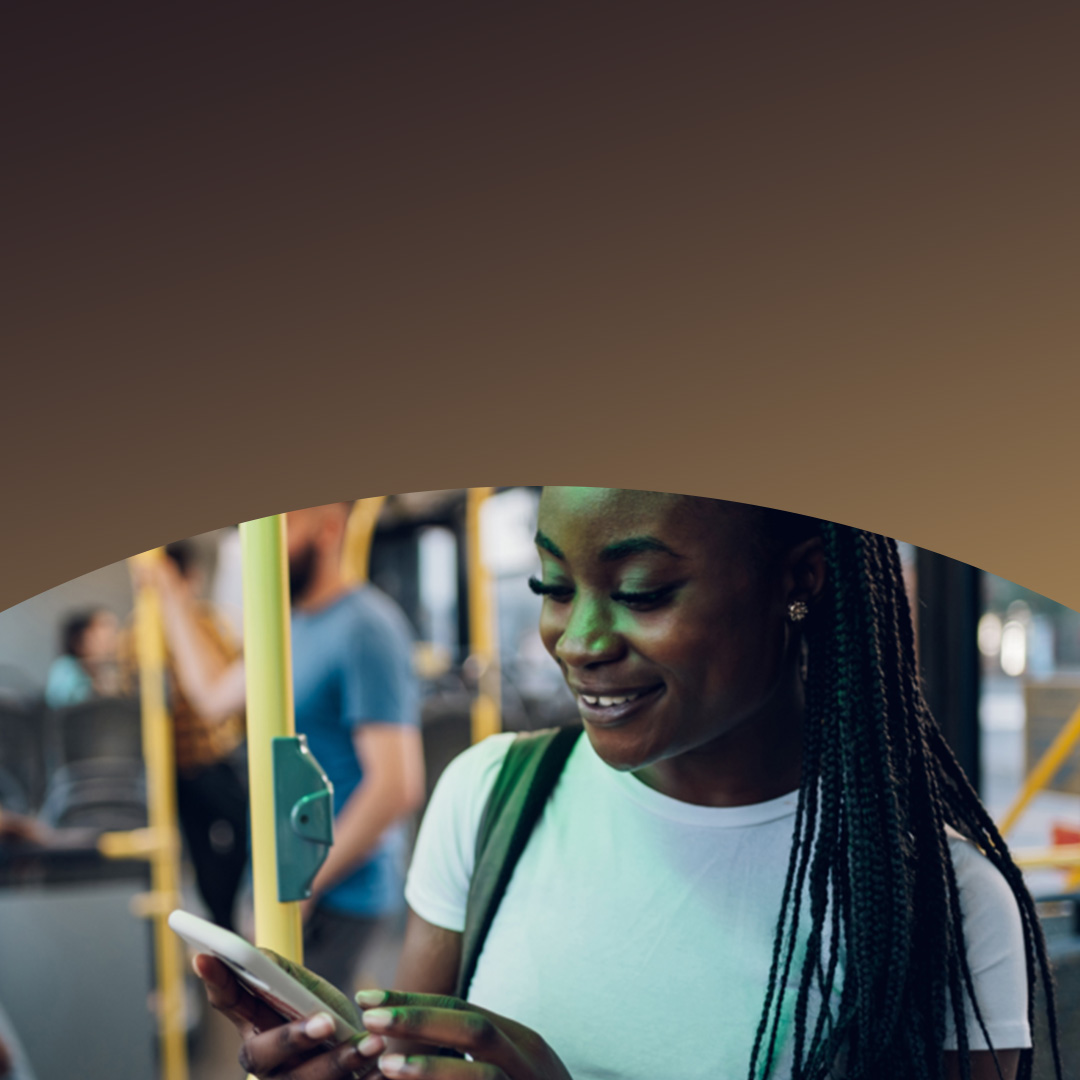 Tânără în tren, uitându-se la telefonul ei