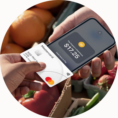 O persoană ține un card contactless pe un smartphone cu funcția Tap on Phone activată pentru a efectua o plată.