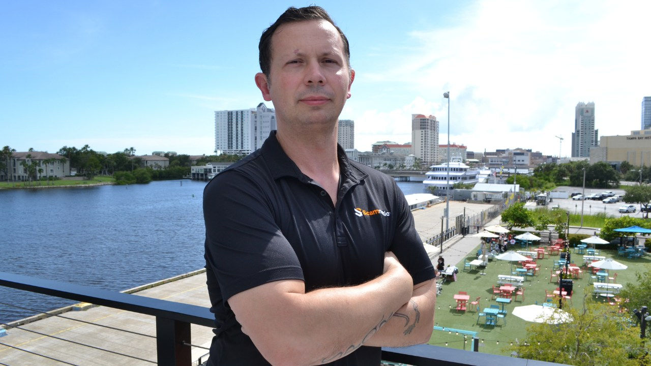 Al Pascual from Scamnetic standing on a deck overlooking a river in Tampa. 