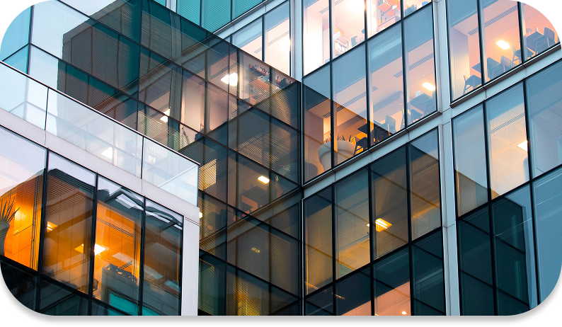 A modern building with multiple windows and a large glass facade.