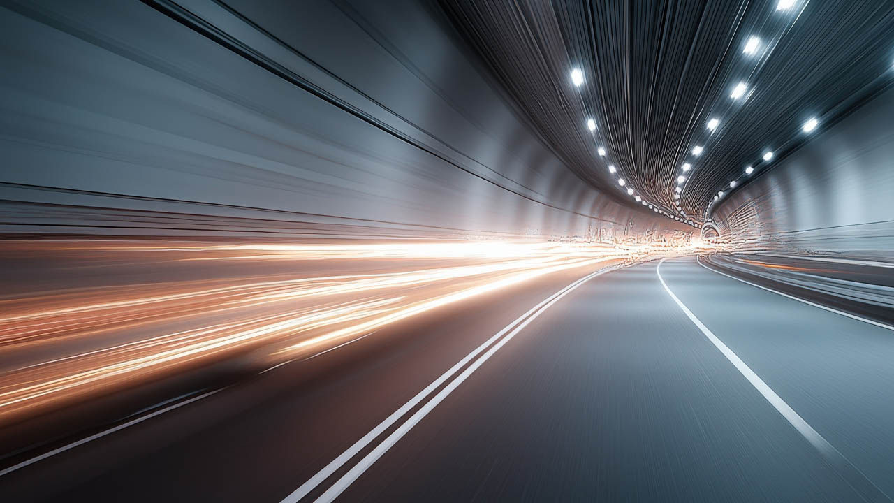 A car drives through a tunnel, surrounded by dynamic light trails illuminating the dark space.