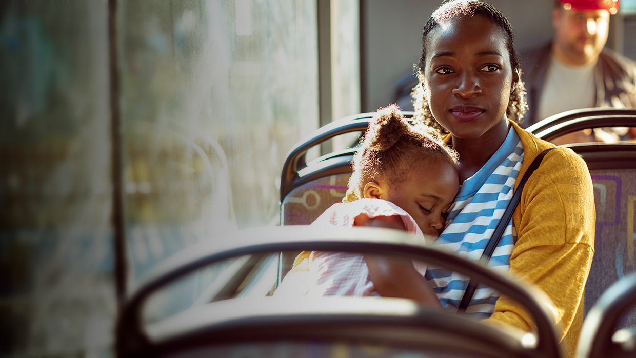 Mère regardant au loin tout en tenant sa petite fille.