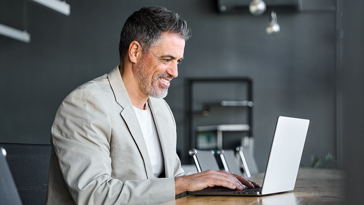 Man typing on laptop.