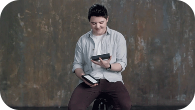Man holding both a smartphone and a tablet.