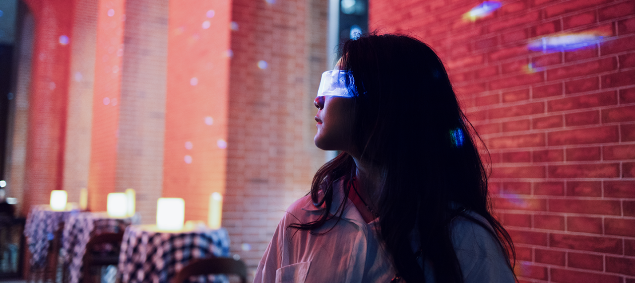 Woman using futuristic tech in restaurant