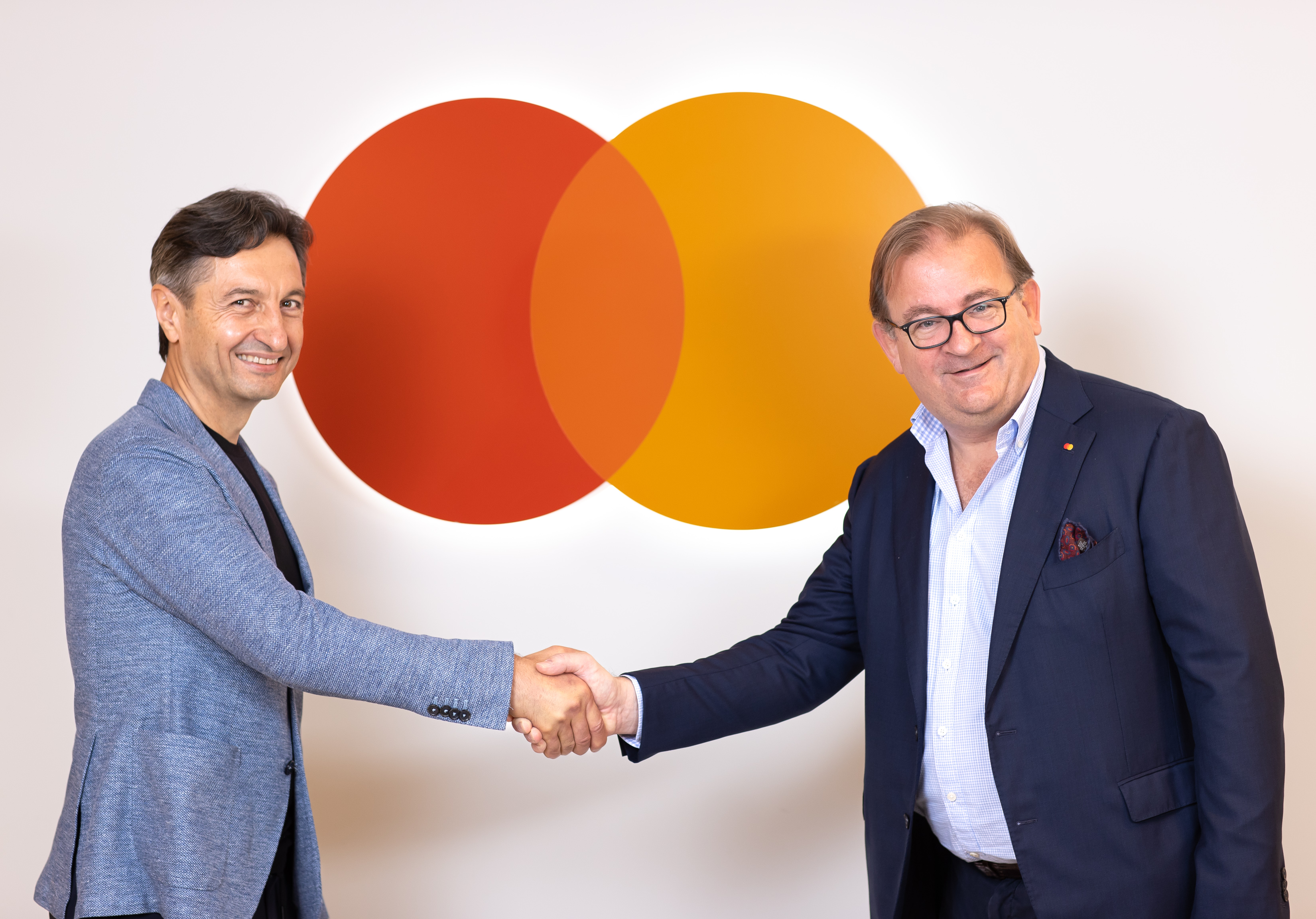 Abdul Abdulkerimov, Co-Founder and Chairman, Paysend shakes hands with Mark Barnett, President, Mastercard Europe