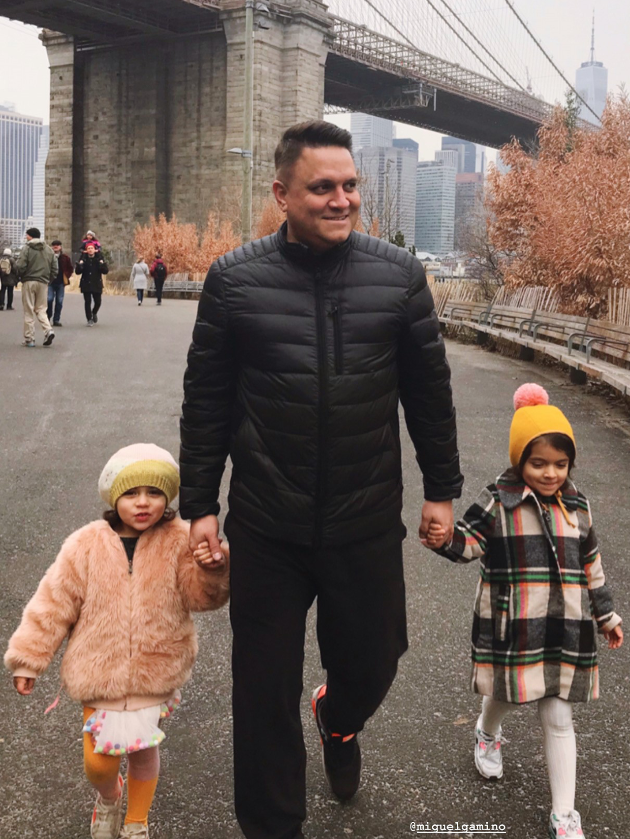 Miguel Gamiño Jr. with his daughters Mariana, 4, left, and Mia, 5, near the Brooklyn Bridge.
