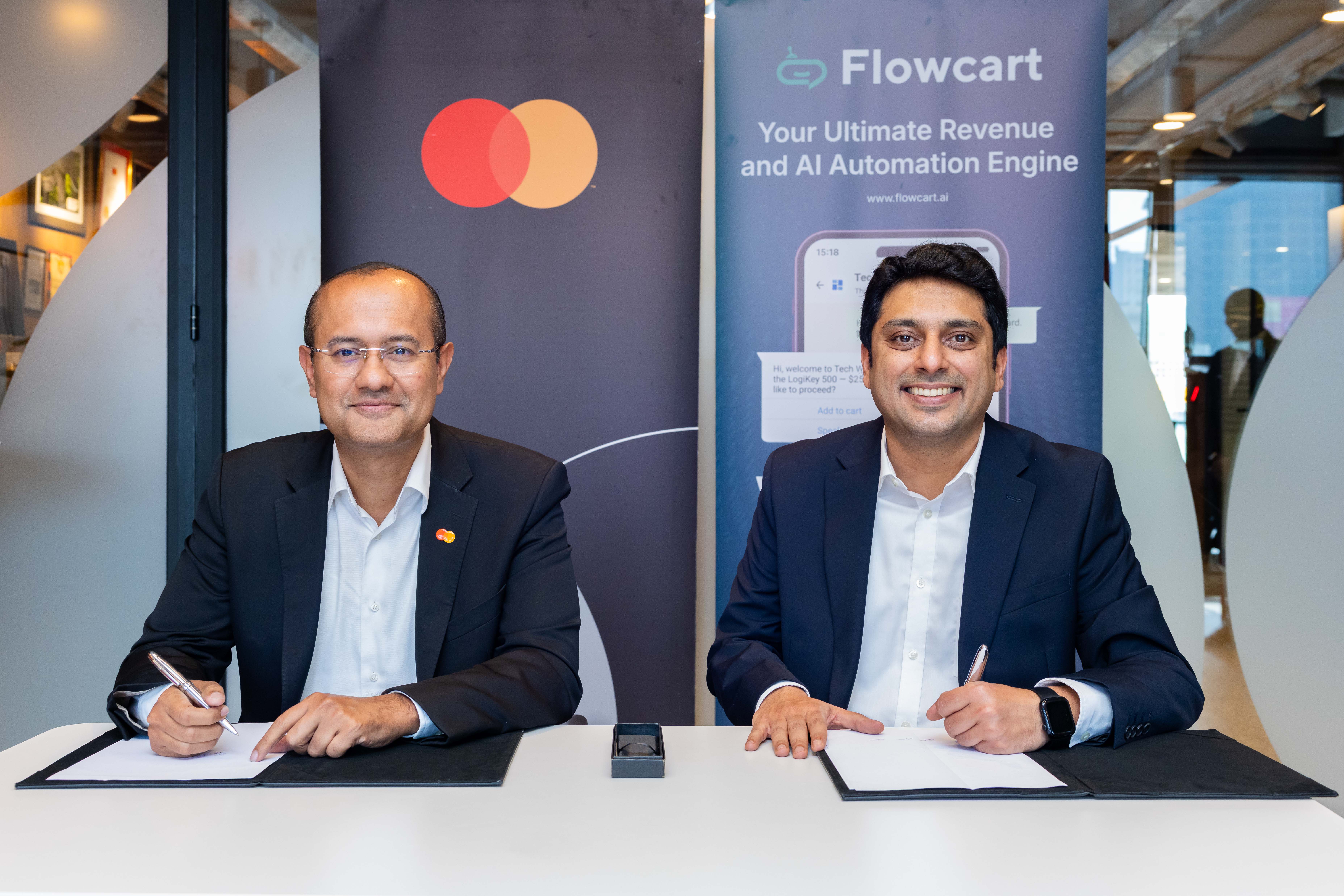 Shehryar Ali, senior vice president and country manager for East Africa and Indian Ocean Islands at Mastercard (left), and Saad Latif, Director of Commercial Operations at Flowcart, sign a strategic collaboration agreement to enable secure, seamless card payments within social and conversational commerce journeys across East Africa.