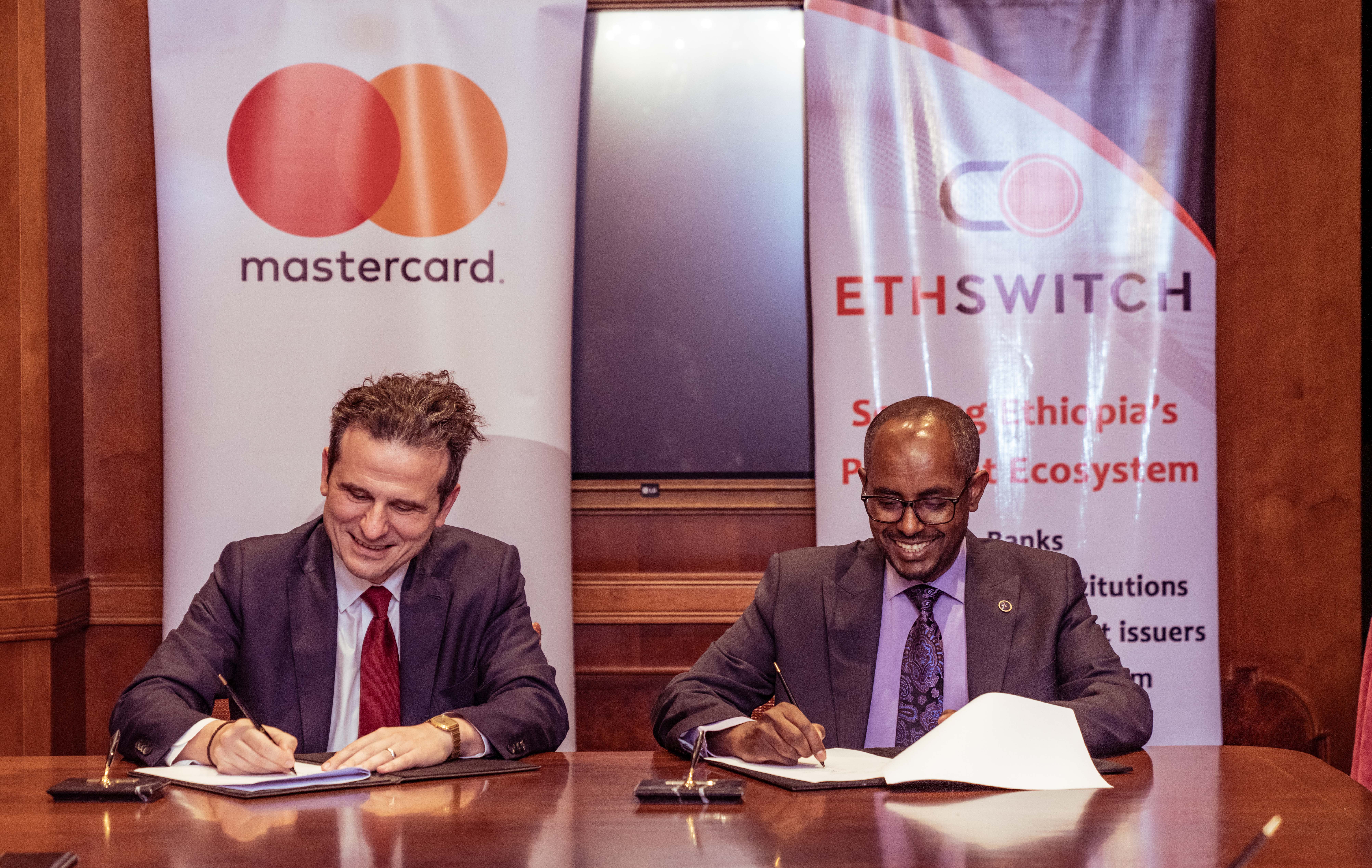 Dimitrios Dosis, President for Eastern Europe, Middle East and Africa at Mastercard and Yilebes Addis, Chief Executive Officer at EthSwitch during the signing ceremony in Addis Ababa, Ethiopia.
