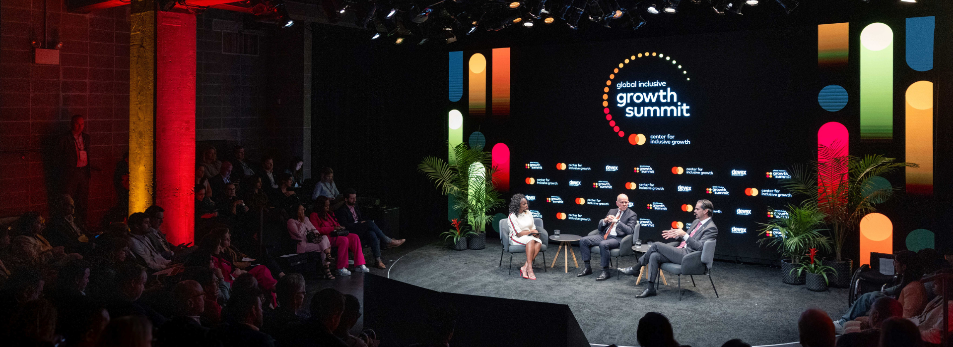 Three people on stage at the Global Inclusive Growth Summit in Washington, D.C. 