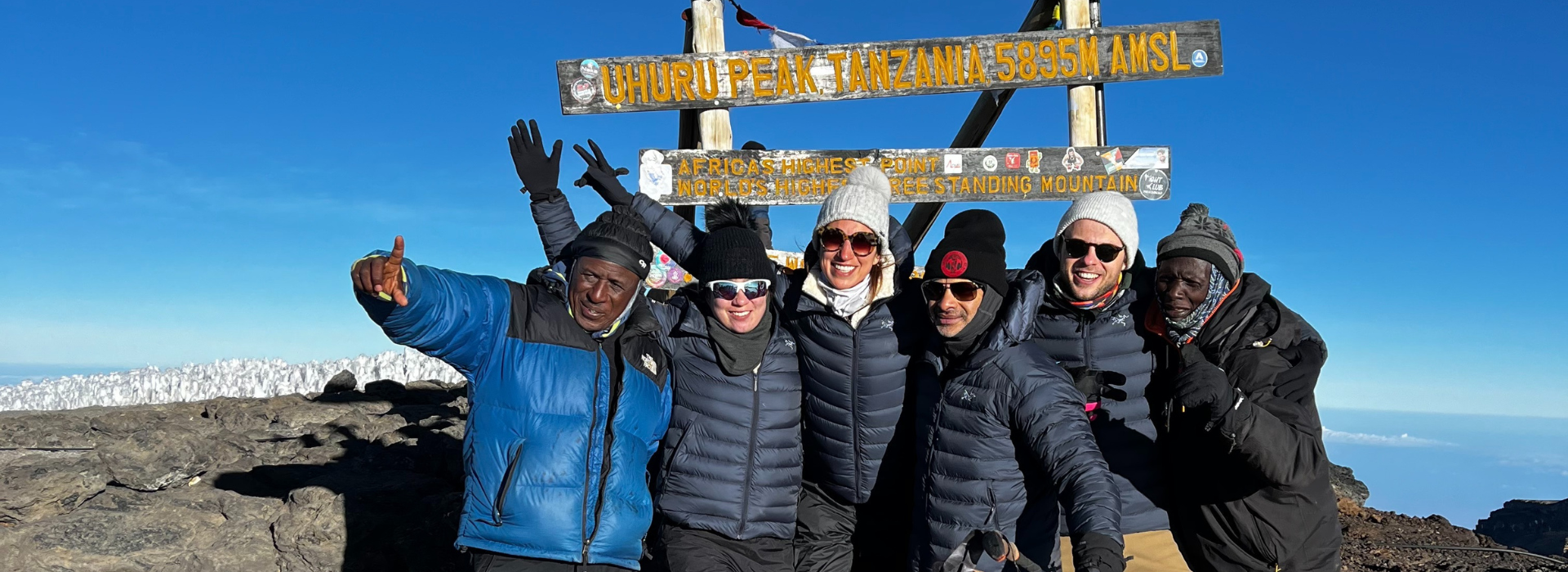 Employees and guides on the top of Mount Kilimanjaro.