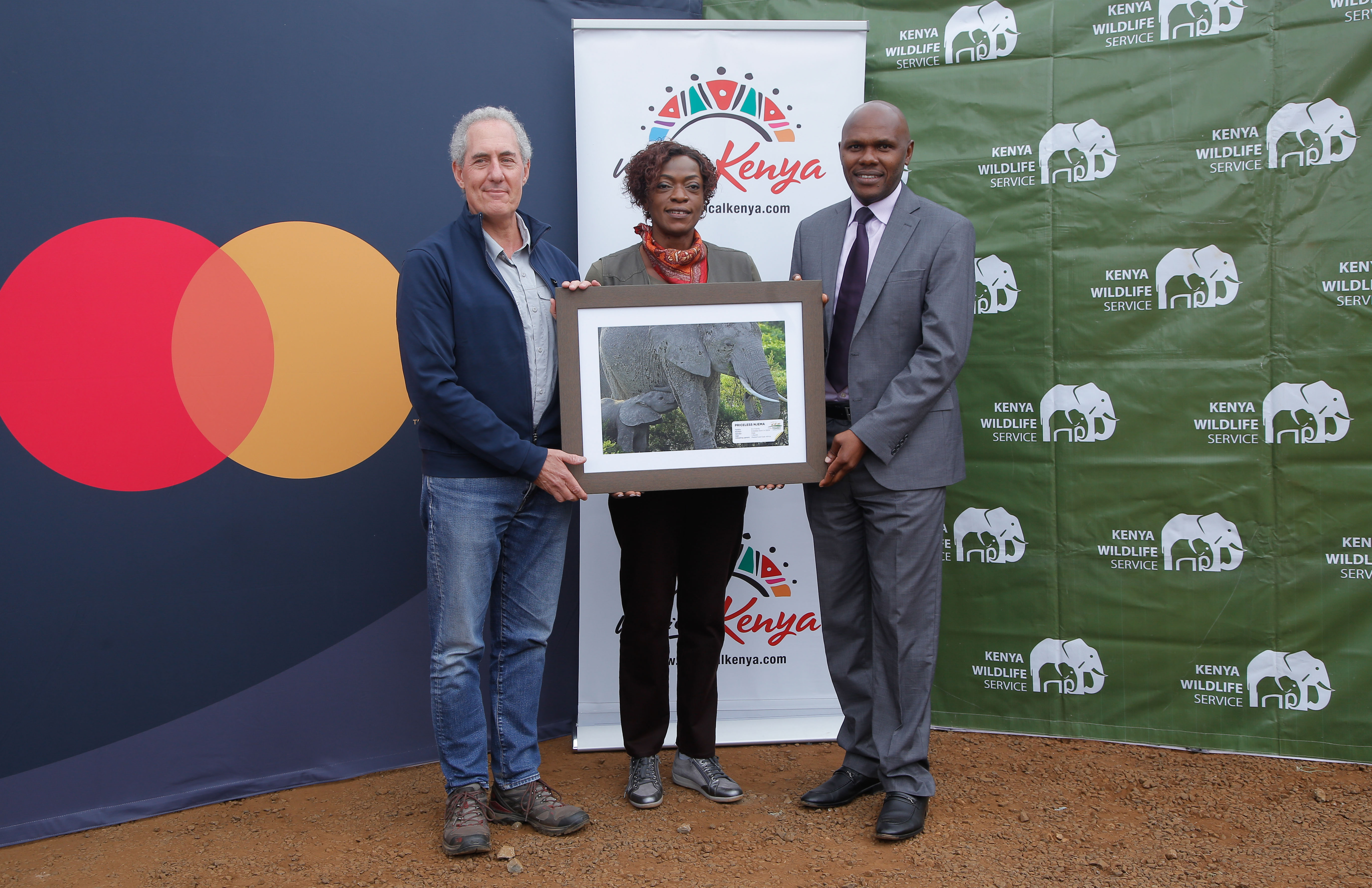 (L-R) Michael Froman, Vice Chairman and President, Strategic Growth for Mastercard, Dr. Betty Radier, CEO, Kenya Tourism Board and Edwin Wanyonyi, Director Strategy and Change, Kenya Wildlife Services, at the Nairobi National Park, for the Magical Kenya Tembo naming festival, an elephant conservation sustainability tactic where Michael Froman had the honor of  naming a one month old elephant “Priceless Njema” which loosely translates to “It is great”. Mastercard has partnered with the Kenya Tourism Board to boost tourism into Kenya by leveraging various channels, including its Priceless.com platform.
