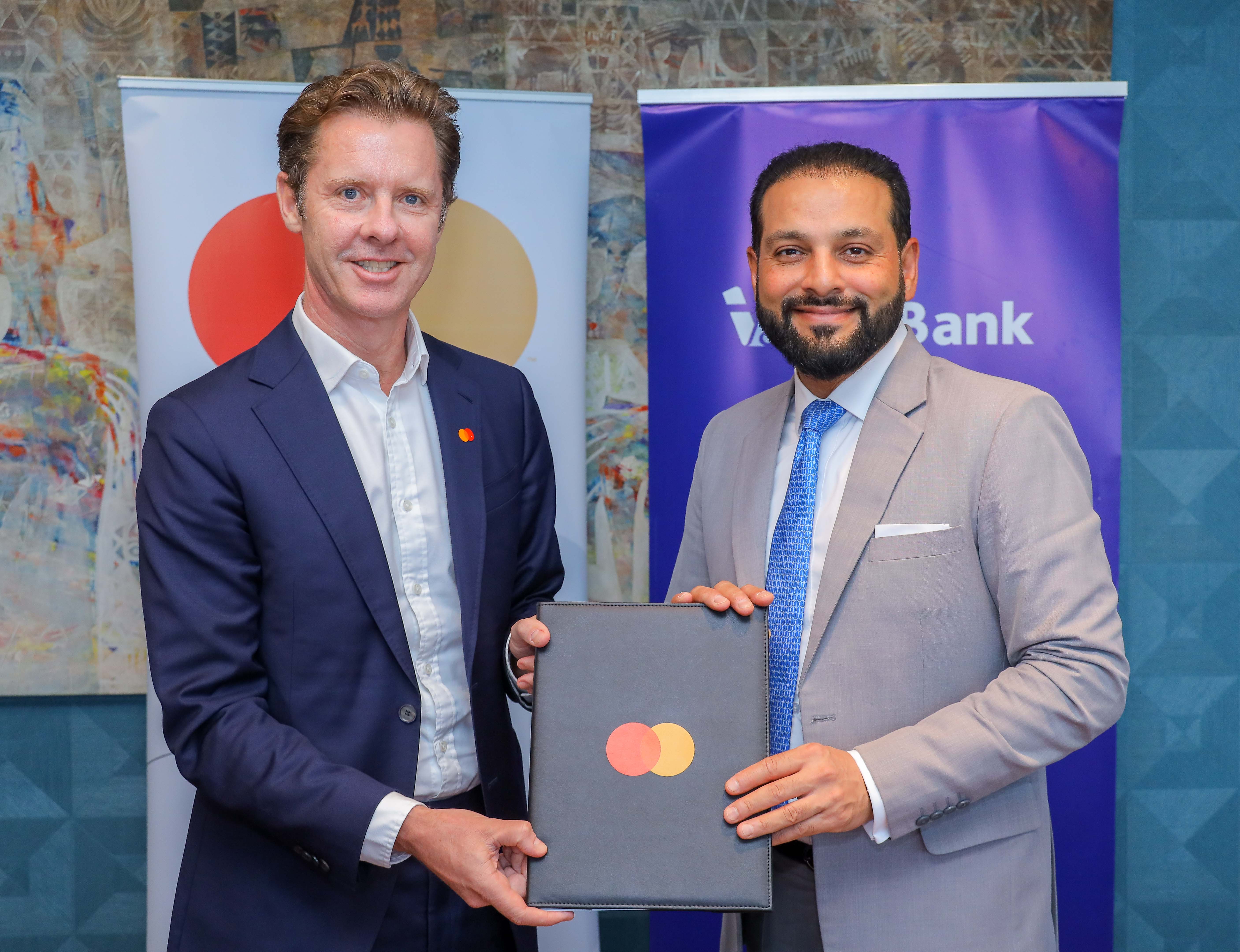 Mark Elliott, President for Africa at Mastercard (L) and Gul Khan, CEO of I&M Bank (R) at the signing of the framework agreement which will extend their strategic collaboration offering enhanced value propositions to cardholders in Kenya