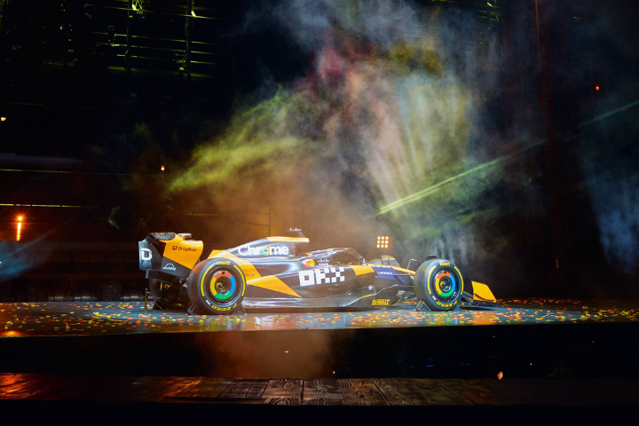 A McLaren race car with Mastercard livery on a stage.