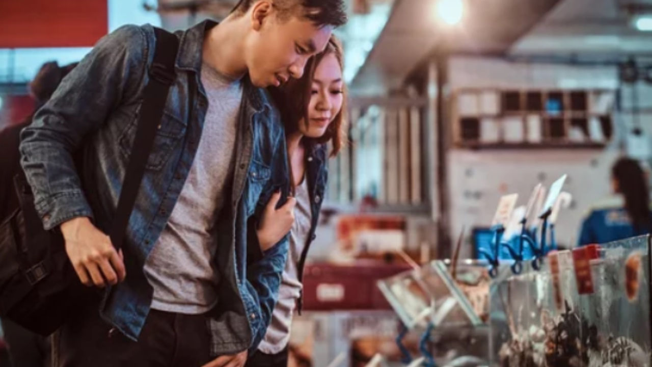 A couple look at a display in a market in Singapore. 