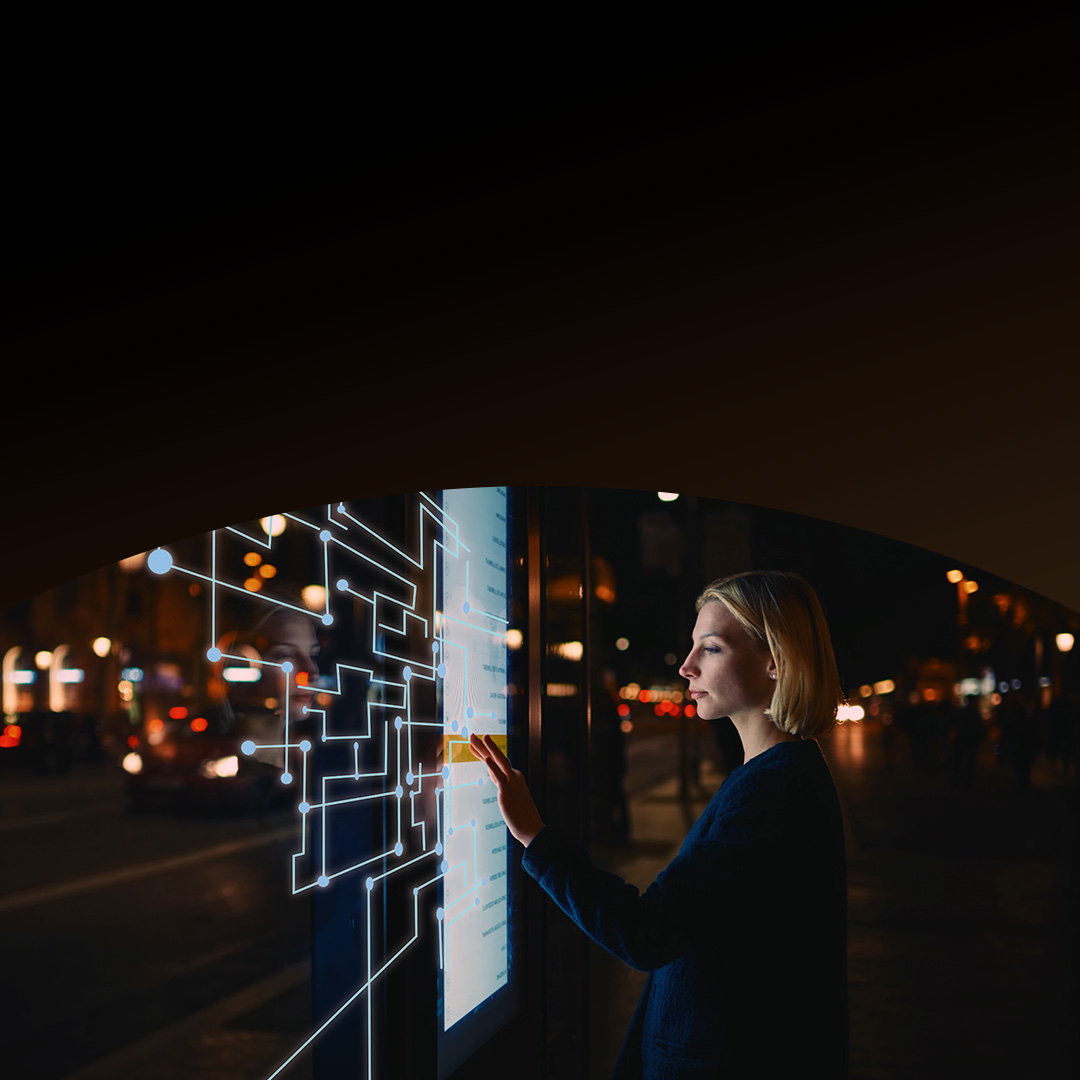Woman short hair using touchscreen at night.