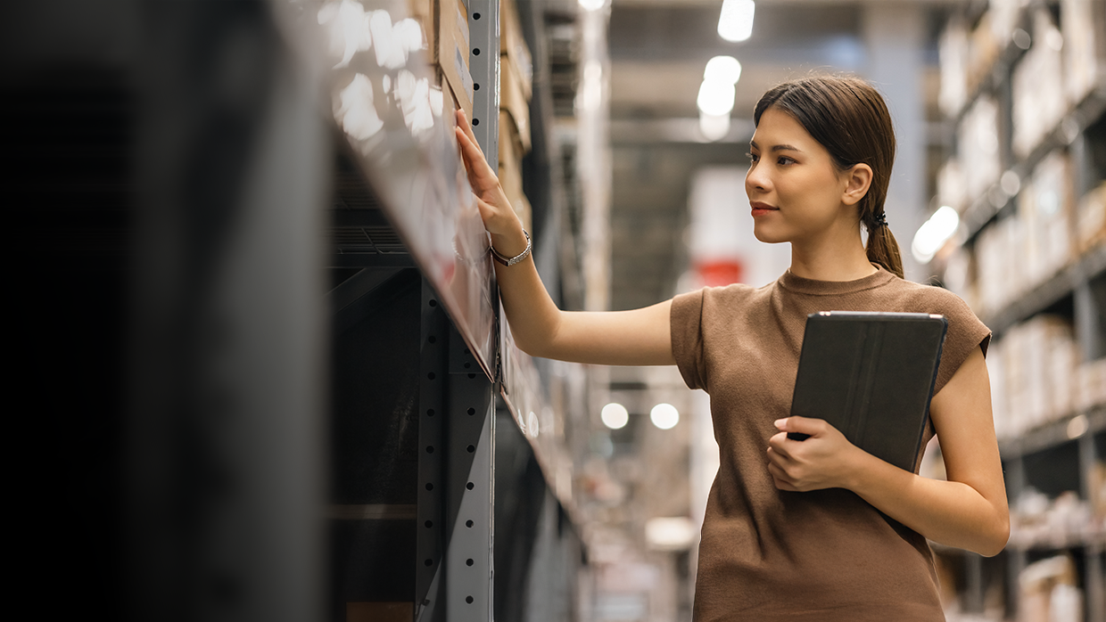 Woman checking inventory in a warehouse.