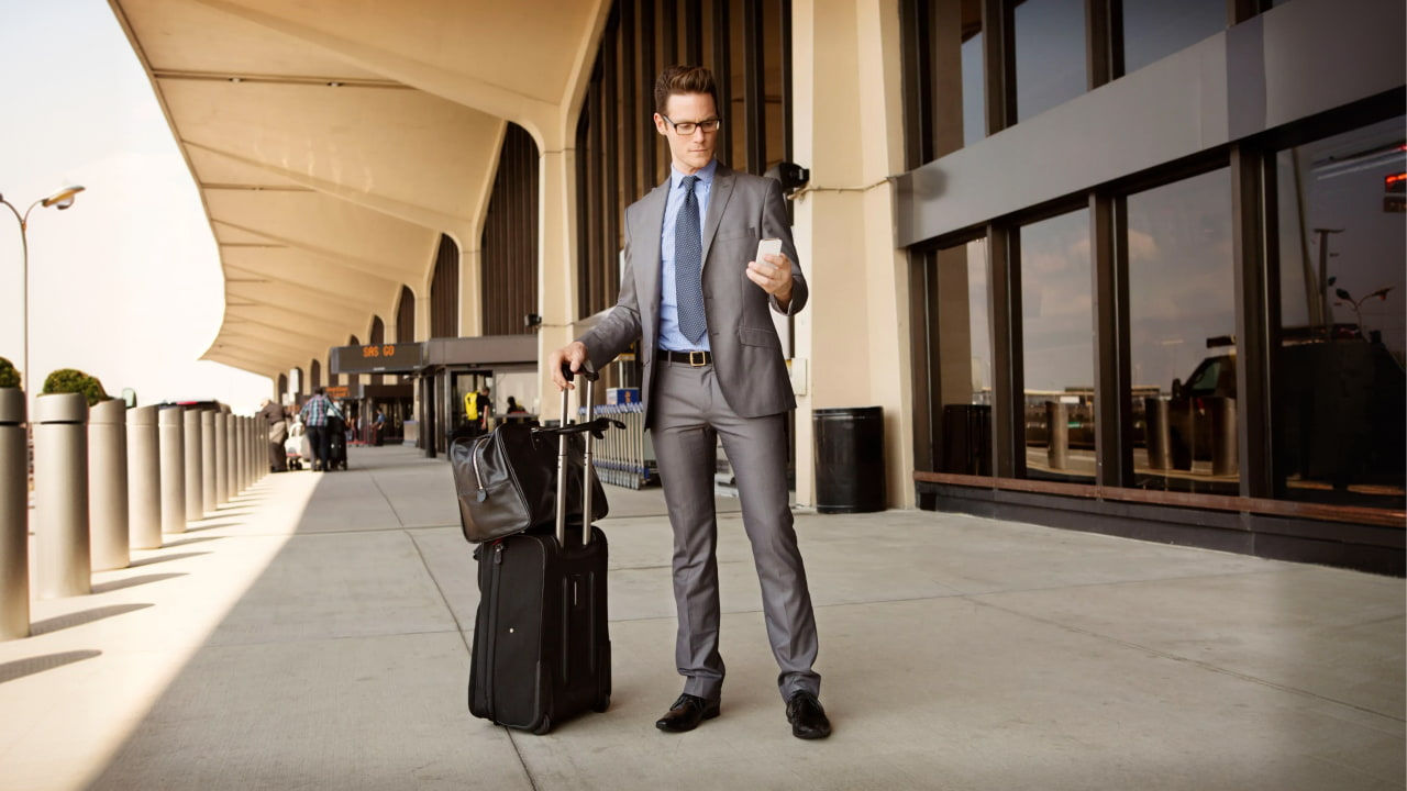 man outside airport waiting