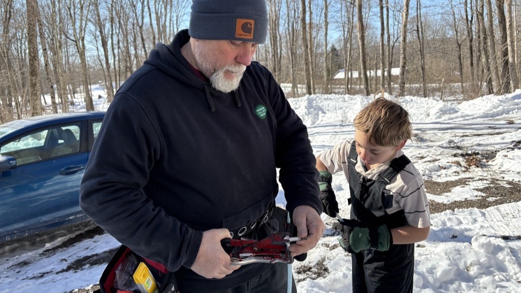 Trevor Ballard assembles a fitting with his son John-Daniel. 