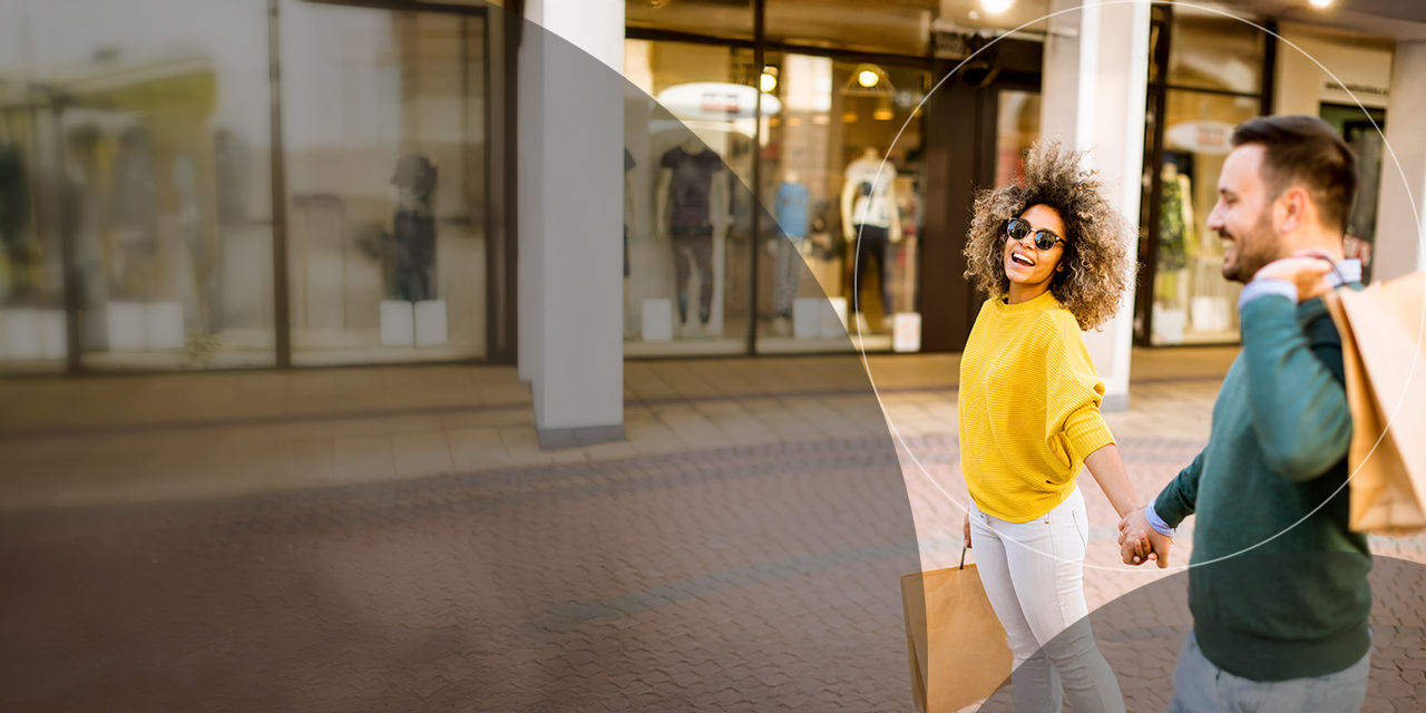 Young couple with bags shopping.