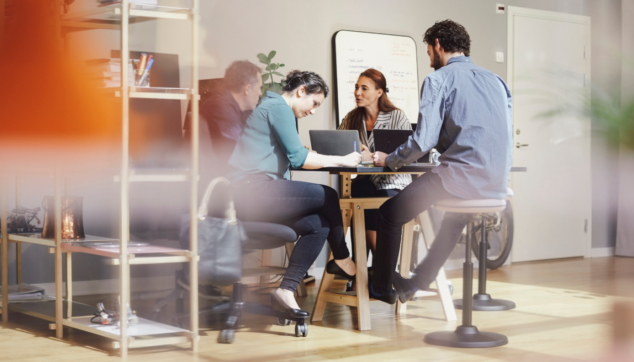 Three people conversing in the break room