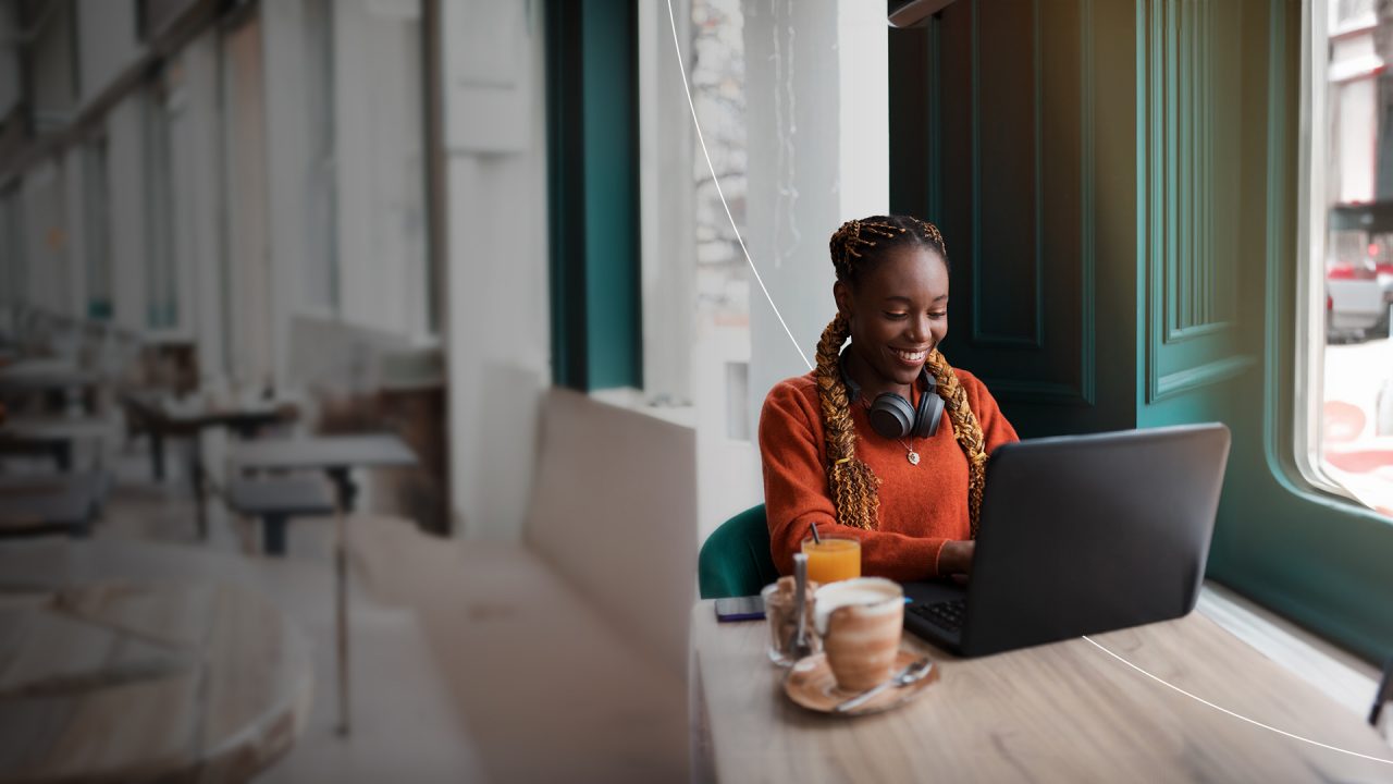 Customer at restaurant on laptop.