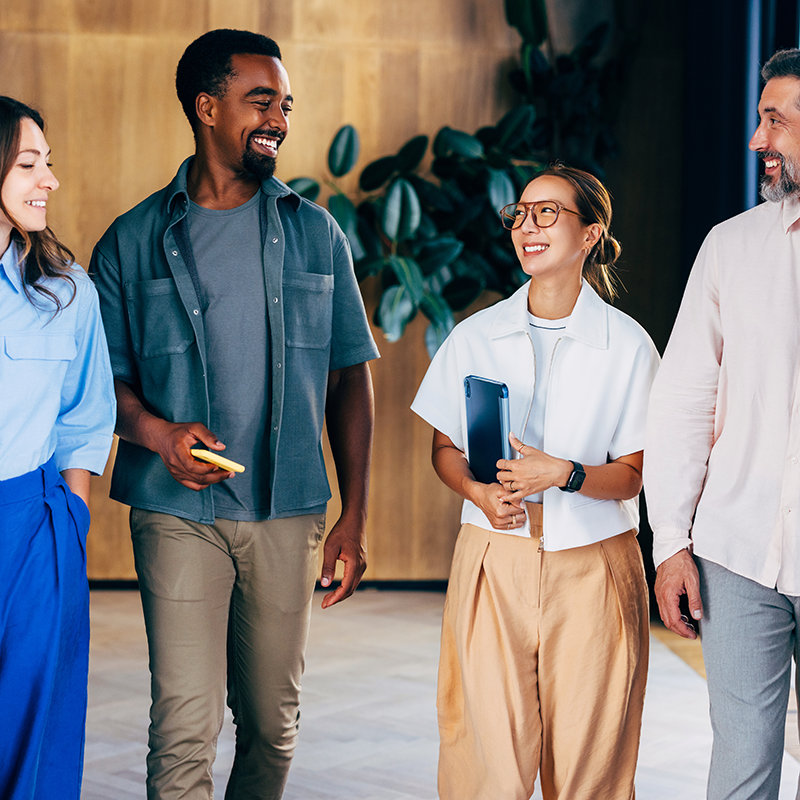 Diverse group of coworkers walking around in the office
