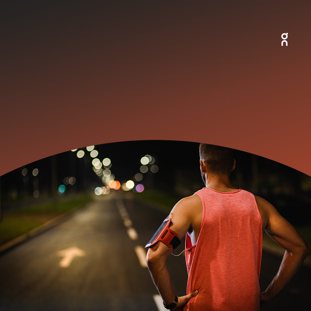 Athlete running on street after dark.