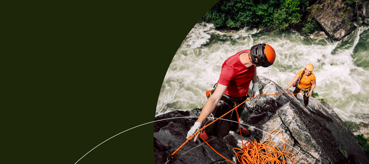 People rock climbing over rushing water