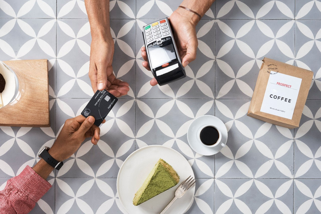 Women walking down steps looking at her phone for identity authentication. 