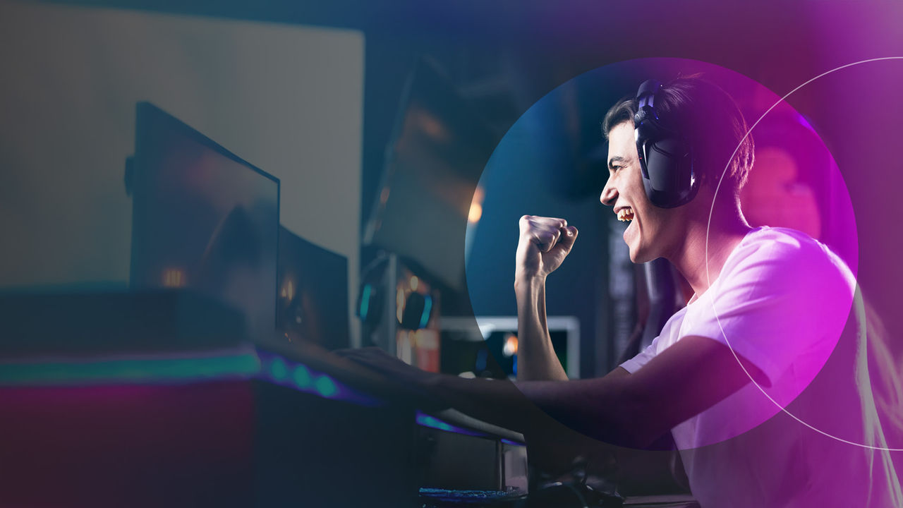 man cheering while playing computer game.