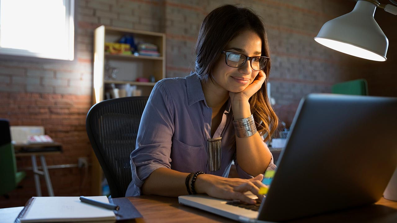 Young woman using laptop at home.